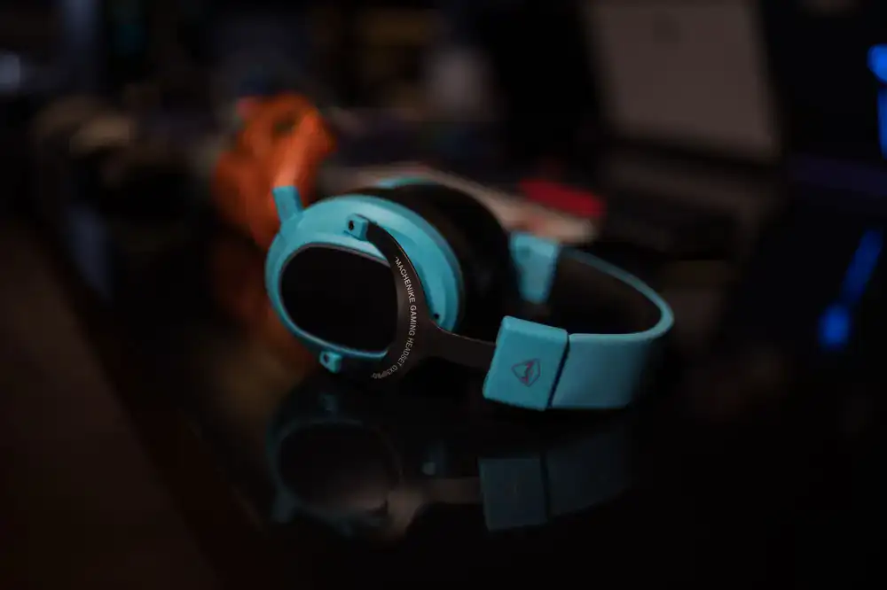 A high quality communications headset resting on a computer desk